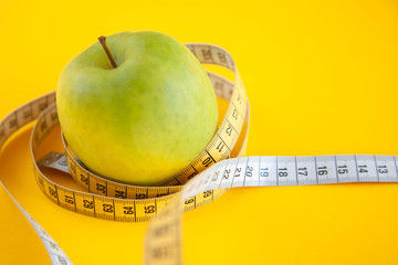 Green apples measured the meter. Healthy food for weight loss.