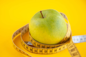 Green apples measured the meter. Healthy food for weight loss.
