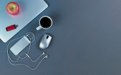Grey desktop with mobile devices and coffee drink in flat lay format for telework or telecommute...