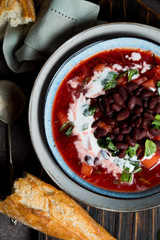 Traditional Ukrainian soup borscht with red beans and sour cream