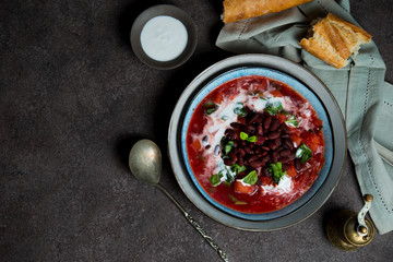 Traditional Ukrainian soup borscht with red beans and sour cream, copy space