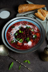 Traditional Ukrainian soup borscht with red beans and sour cream