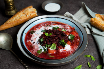 Traditional Ukrainian soup borscht with red beans and sour cream