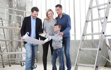 Fototapeta premium Architect showing house design plans to a family with child. Meeting at interior construction site to talk about house appearance, interior decoration, home layout and wall colors