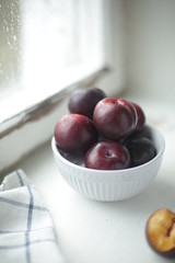 on a light background a plate with a plum
