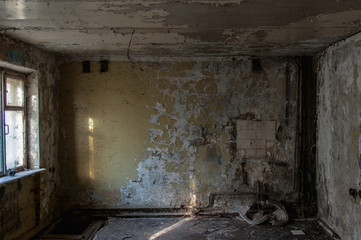 abandoned hotel building. abandoned room with cracked walls and peeling paint. broken sink and...