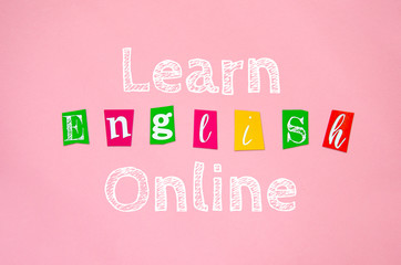 LEARN ENGLISH ONLINE phrase isolated on pink. Study at home flat lay