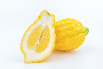 Typical sicilian lemon Piretto and its cutted slice isolated on white background