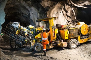 Miner climbing on a mineral mining machine