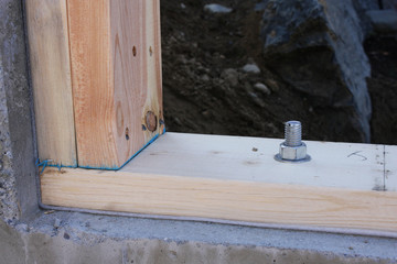 wood bolted to concrete