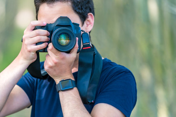 young man photographer in nature. copy space