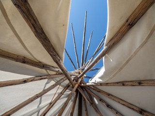 Blue sky peeking out from opening of teepee.