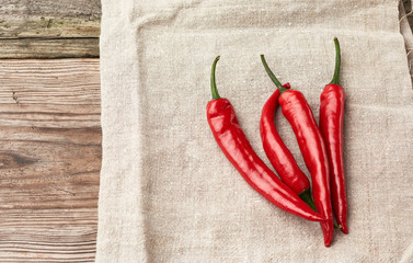 raw red chili peppers on a gray linen towel