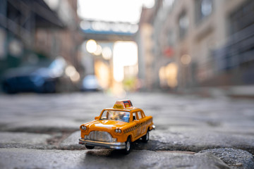 Classical taxi model car parked on an old street in Brooklyn near Brooklyn bridge.