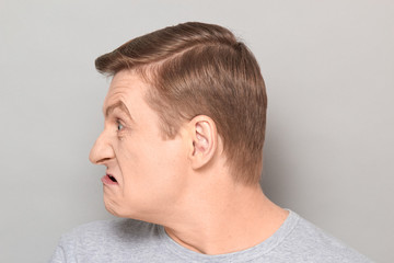 Fototapeta premium Portrait of blond mature man with angry annoyed expression