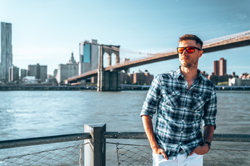 Young guy standing by the Hudson river in New York city.