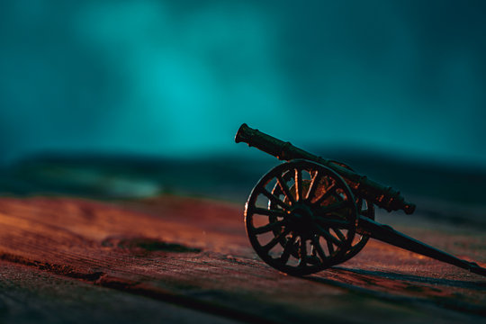 Ramadan Cannon with Colorful Light Glowing at Night and Glittering with Bokeh Lights on Ground. Festive Greeting Card, Invitation for Muslim Holy Month Ramadan Kareem. Blue Dark background