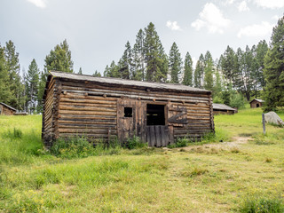 Abandoned log buildings in western ghost town.