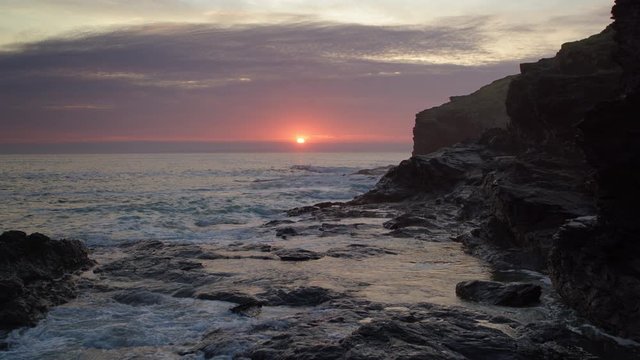 Dramatic Sunset in Cornwall. (Slow moving aerial shot)