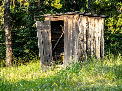 Abandoned two seater outhouse in woods