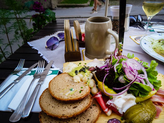 Austrian Brotzeit platter with wide selection of vegetables and sausages with beer