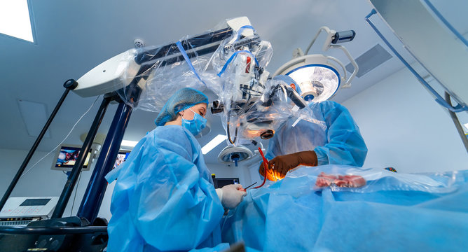 Medical team performing operation. Group of surgeon at work in operating theatre