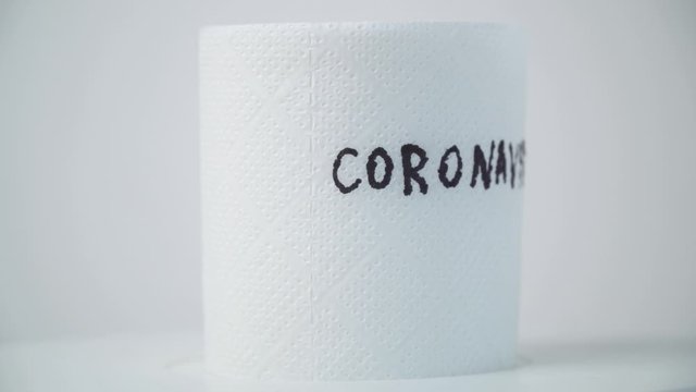 Toilet paper with text coronavirus. Concept of lack of toilet paper in stores due to coronavirus. Covid-19, hygiene, panic