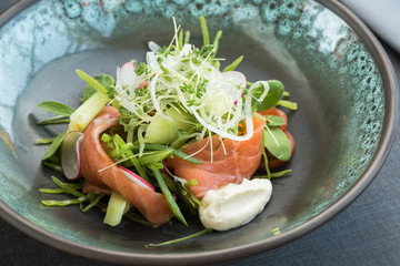 Salmon salad with fresh vegetables, cucumber