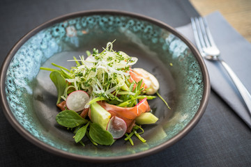 Salmon salad with fresh vegetables, cucumber