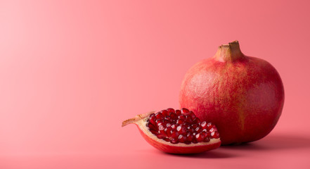 Close up panoramic photo of tasty delicious fresh pomegranate isolated over pastel color background...