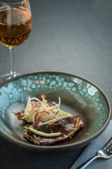 Cooked salmon fillet with root salads and onions