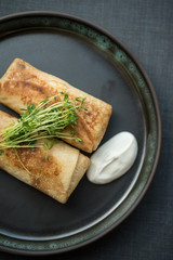 Filled pancakes with sour cream