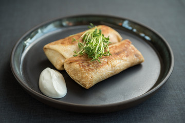 Filled pancakes with sour cream