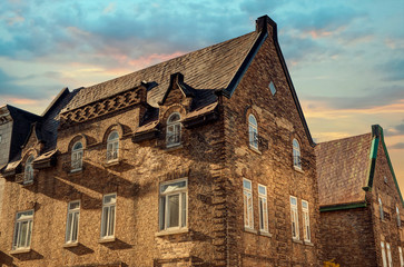 Fototapeta na wymiar Old buildings in Quebec City, Canada. Sunset in background.