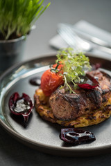 Grilled meat steak on a potato pancake