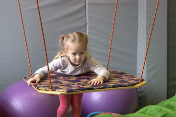 girl in tape made of elastic material. sensory experience, enhance tactile and sensitivity