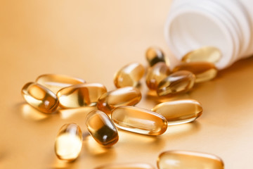 Many capsules Omega 3 on yellow background. Close up, high resolution product. Health care concept.