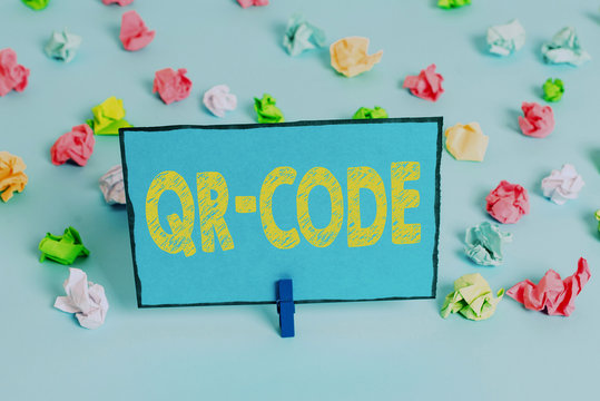 Writing note showing Qr Code. Business concept for the trademark for a type of matrix barcode A machinereadable code Colored crumpled papers empty reminder blue floor background clothespin