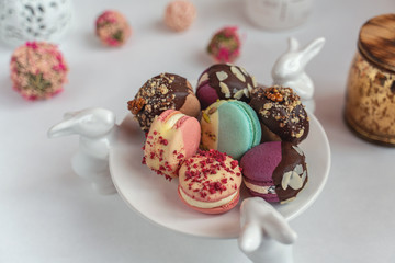 Macaron cake of different colors of large size in a beautiful layout on a light white background