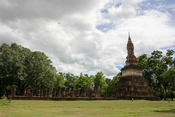 Landscape with vegetation, ruins and a Buddha in Sukhothai
