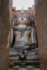 Sukhothai stone Buddha Wat Si Chum through the wall