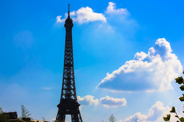 Eiffel Tower in Paris: silhouette of a tower against a blue sky in summer.