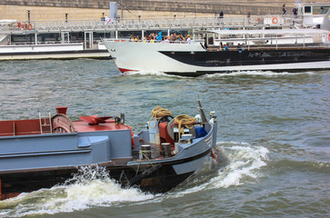 Walking boat with people on board on the Seine River in Paris, summer holidays in Europe. Tourists...