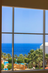 Beautiful sea view from a large window: a luxurious coastal mansion