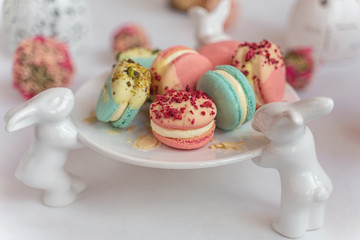 Macaron cake of different colors of large size in a beautiful layout on a light white background