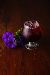 Cocktail in ice bar on blurred wooden background