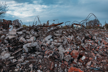 Remains of demolished old industrial building. Pile of stones, bricks and debris