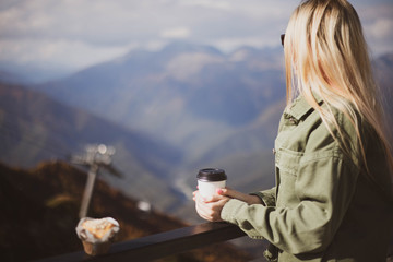 Blonde girl beautiful long-haired traveling in the mountains.