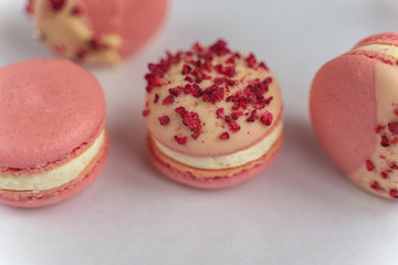 Macaron cake of different colors of large size in a beautiful layout on a light white background