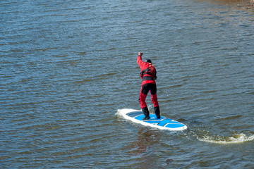 SUP silhouette of athletic man with paddle boarding
